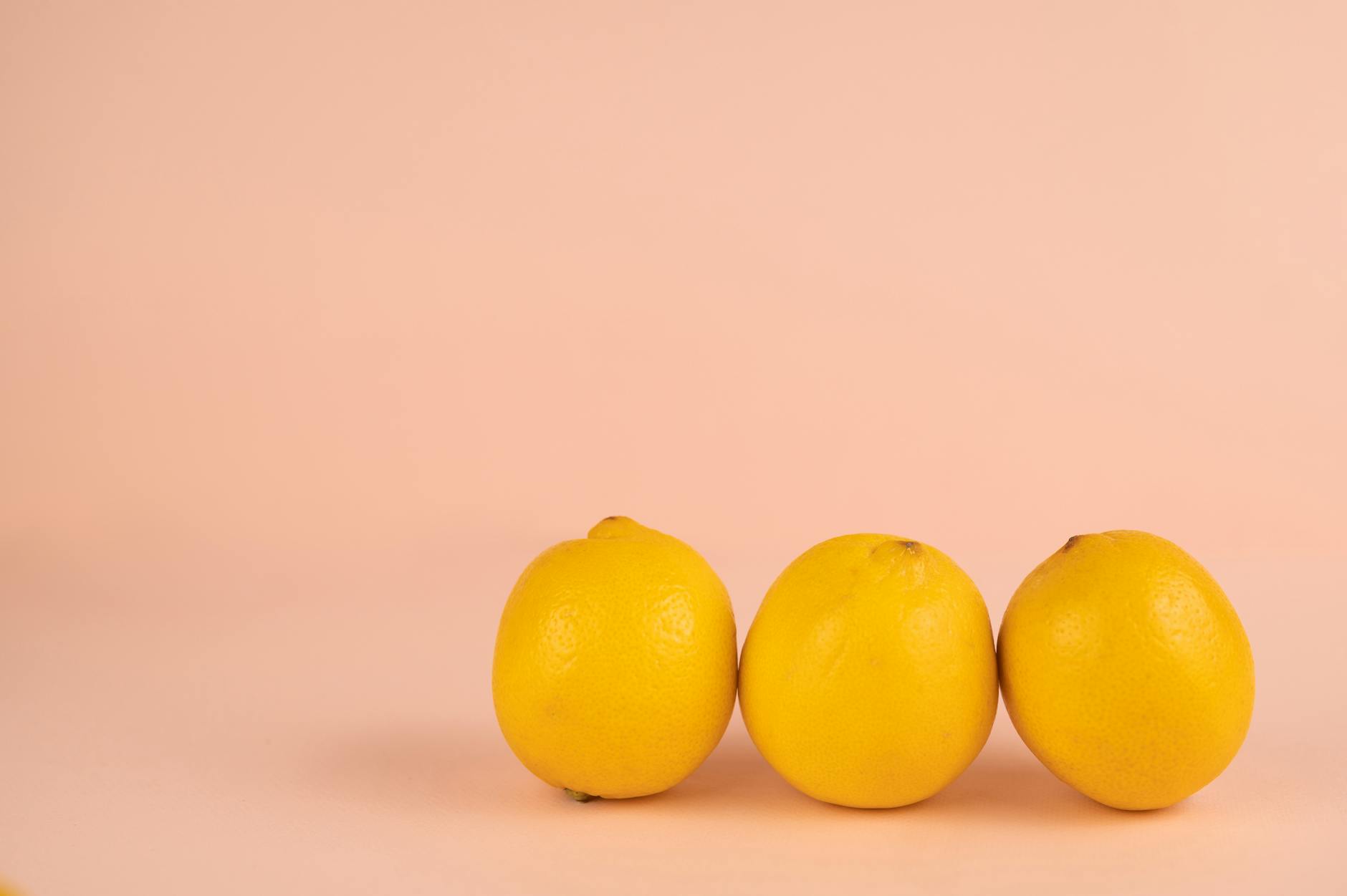 Bright yellow lemons arranged on a pastel background, symbolizing tactile sensation and sensory reconnection